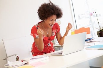 Excited Woman Working At Desk In Design Studio