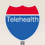 Interstate Road Sign With "Telehealth" Written On It