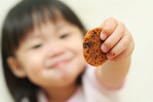 Cute kid sharing a cookie