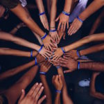 Group of people putting their hands in