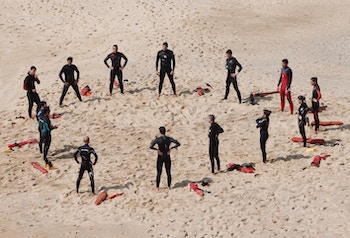 Lifeguards meeting in a circle on the sand