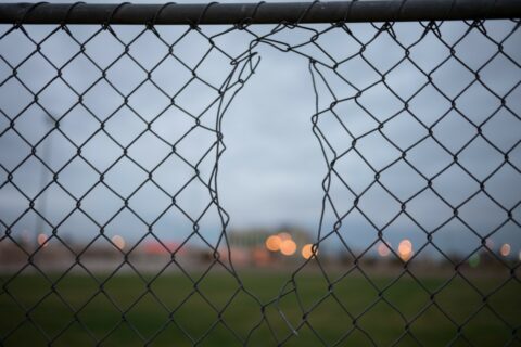 Chain link fence with a hole in it