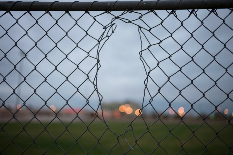 Chain link fence with a hole in it